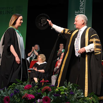 student on stage graduating