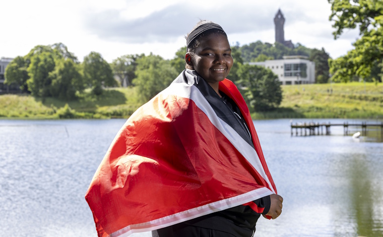 Gabriella Wood with the flag of Trinidad and Tobago.