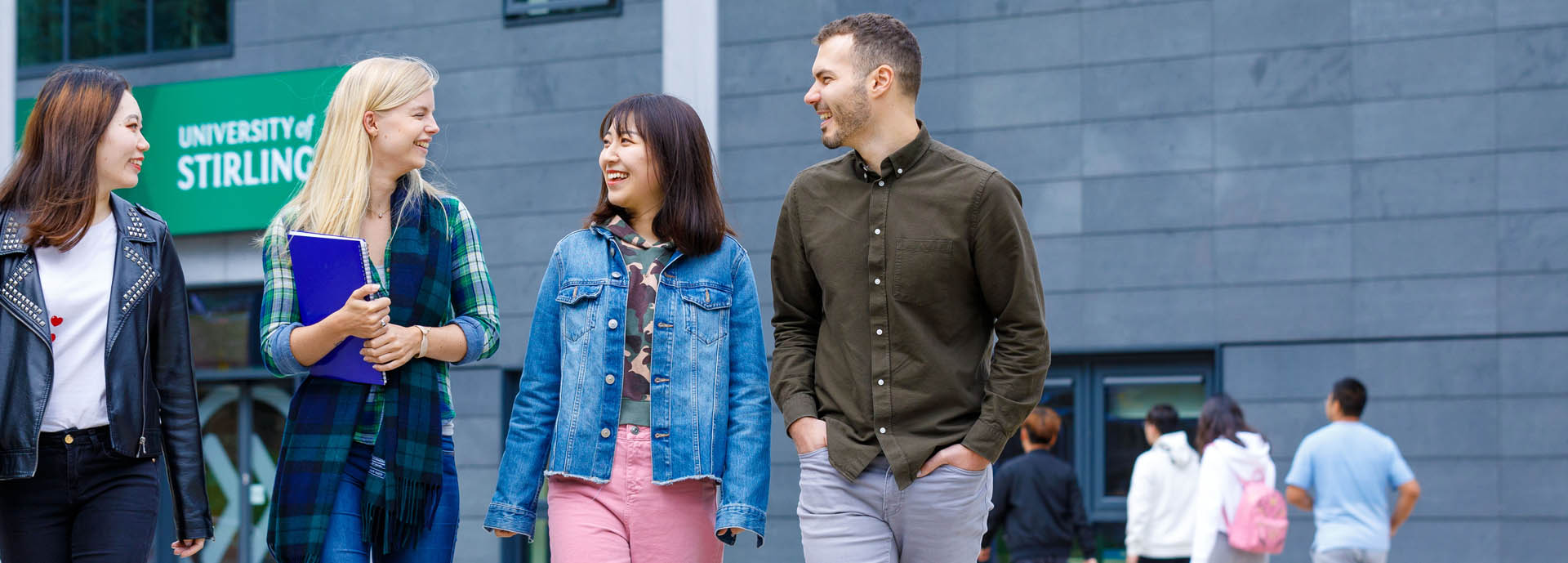 Four students walking on university campus