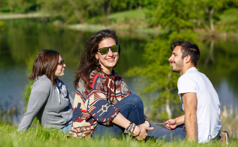 Students sitting near Airthrey Loch