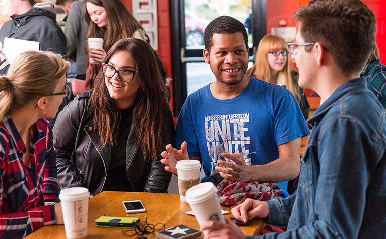 Group of students talking and laughing at Underground