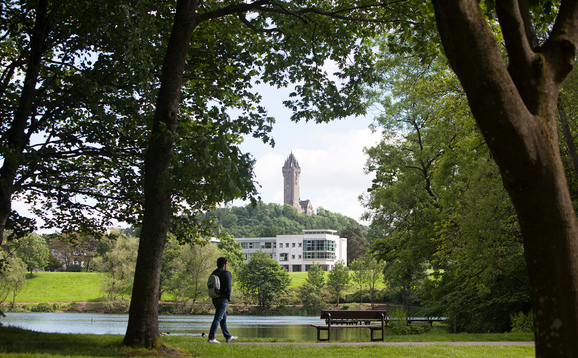 student walking on campus wallace monument