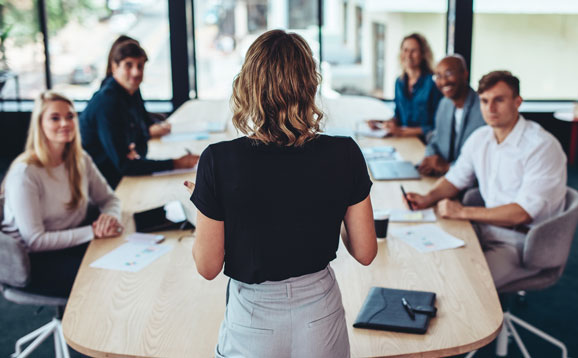 A businesswoman addressing a meeting in a conference room