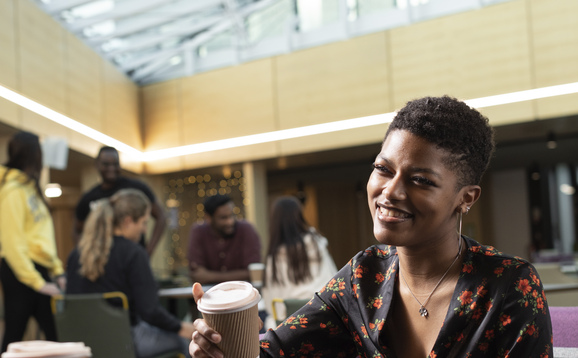 Student having a coffee in the atrium