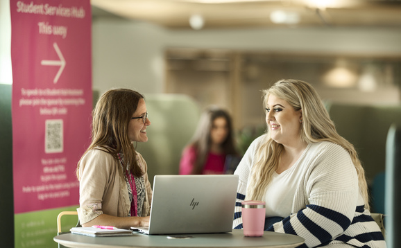 People talking in the Student Services Hub