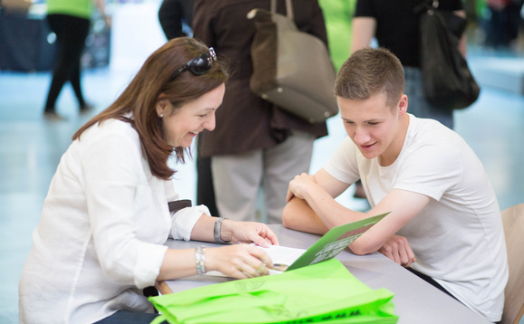 People looking at an open day programme