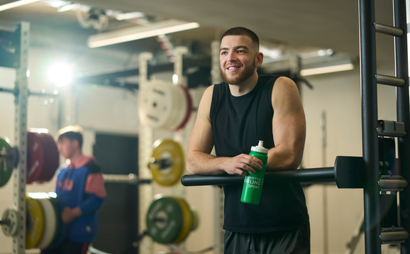 Person in gym holding a water bottle