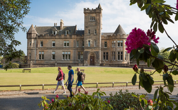 Group of people walking in front of Airthrey Castle