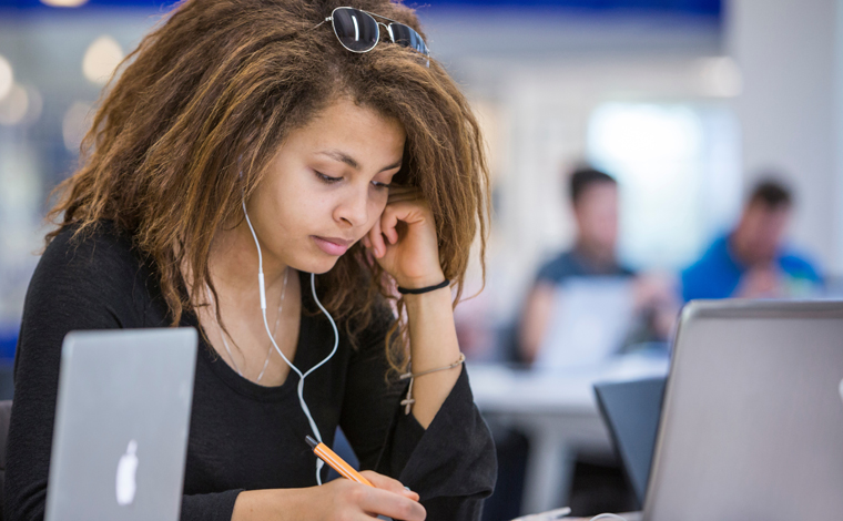 student studying in library