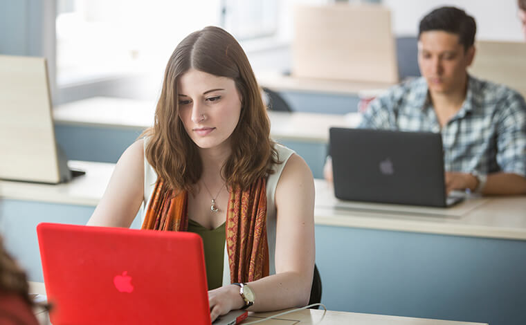 Male and female students studying in a classroom