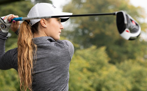 A golfer swinging their club