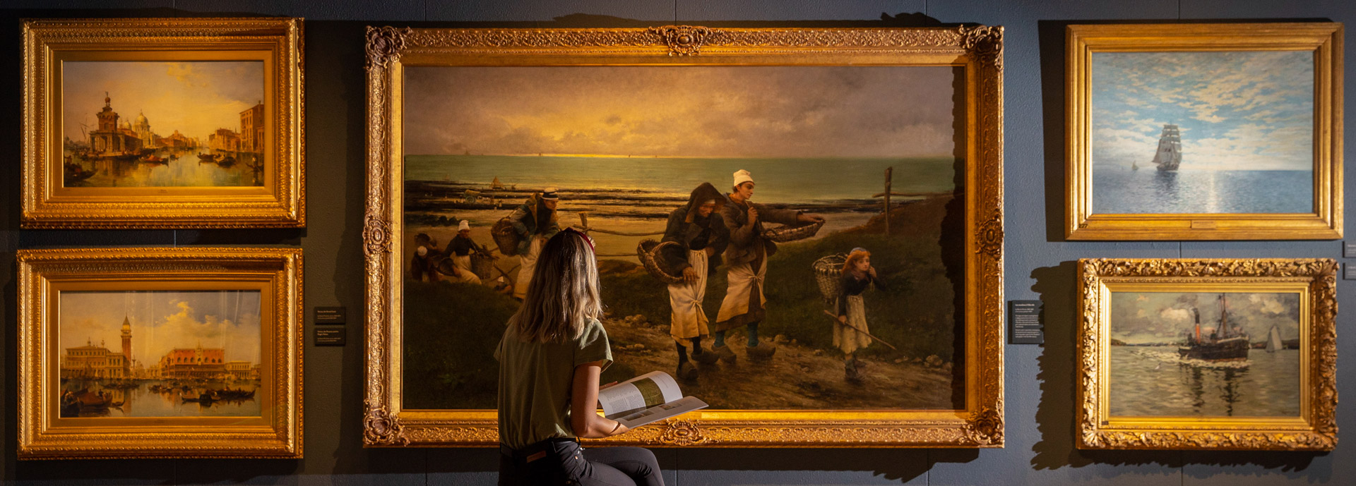 A student admiring a painting at the Smith Art Gallery