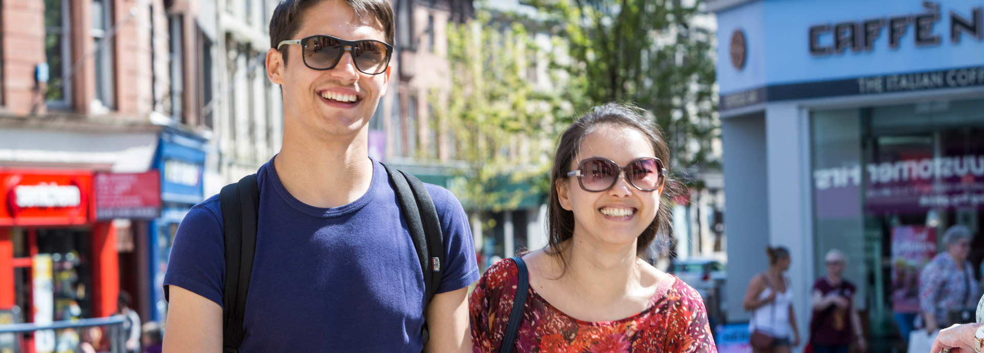 Two happy students shopping in Stirling city centre on a sunny day