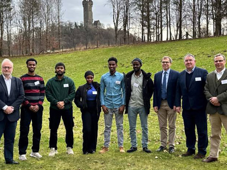 Russell Napier stood on the University grounds with five Karen Napier scholars