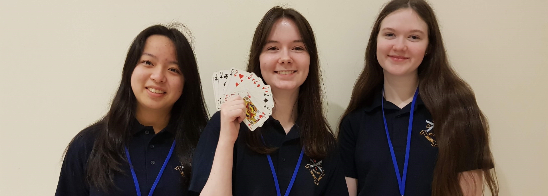 three girls with playing cards