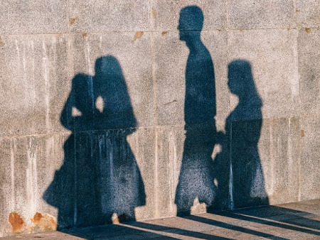 A silhouette of a family on a wall