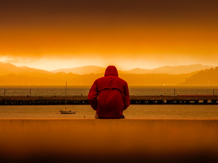 Man sitting at harbour