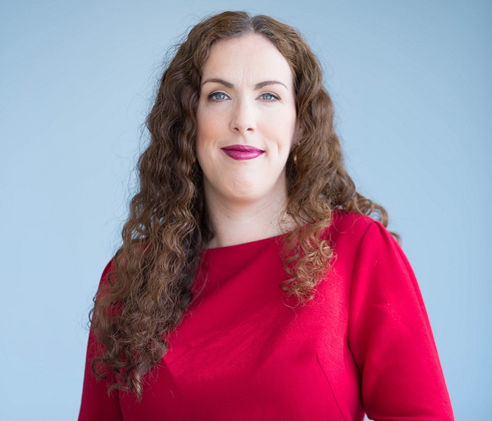 Head and shoulders shot of woman in red top