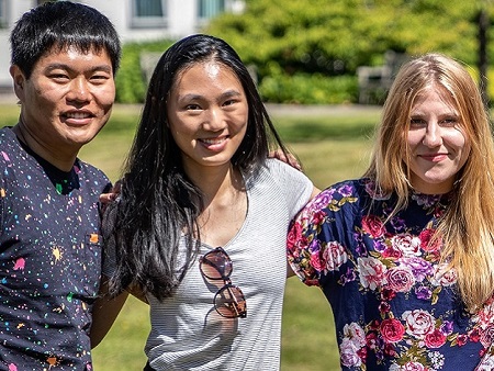 group of three students with arms around each other