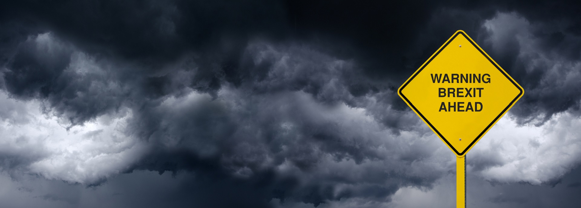 Brexit sign against grey clouds