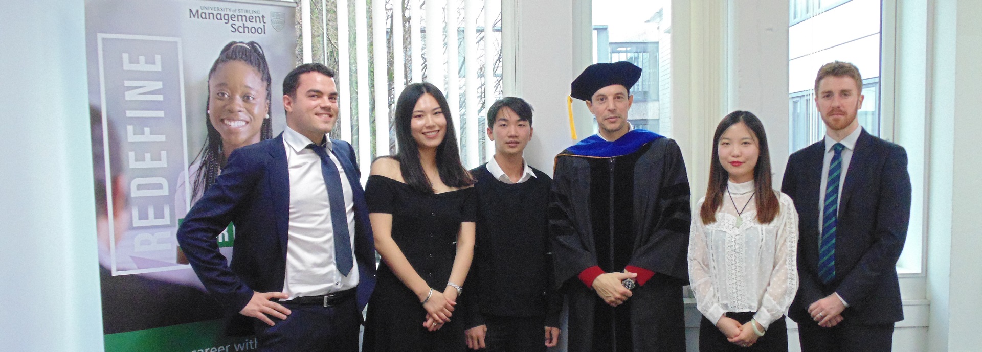 Group of students and academics in a row