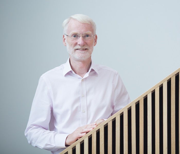 man with grey hair and beard in shirt and tie