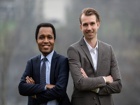 Two MBA students standing with arms crossed outside the University of Stirling