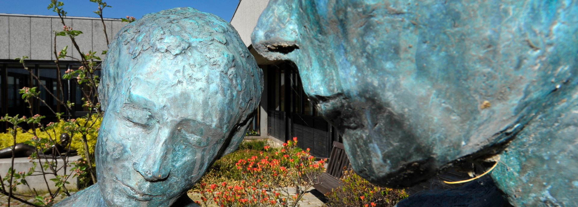 Close up of faces of Adam and Eve sculpture