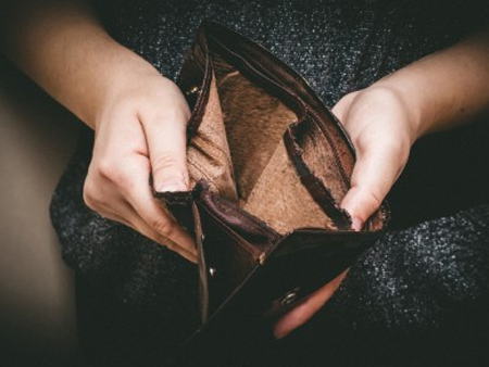 A woman holding an empty wallet