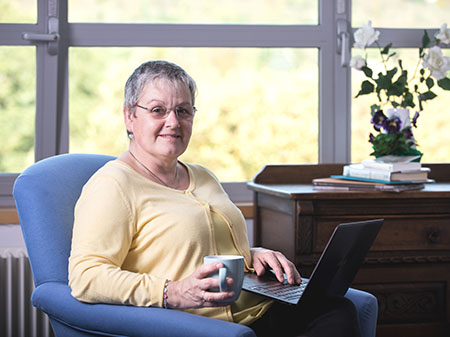 Person sitting in a chair using a laptop