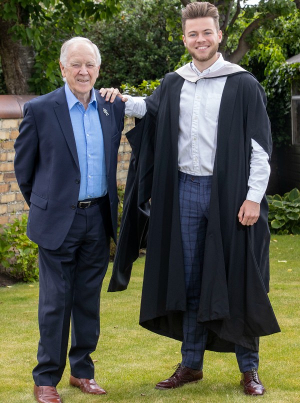 Craig Brown Snr. stands next to Craig Brown Jnr photograph is taken outside