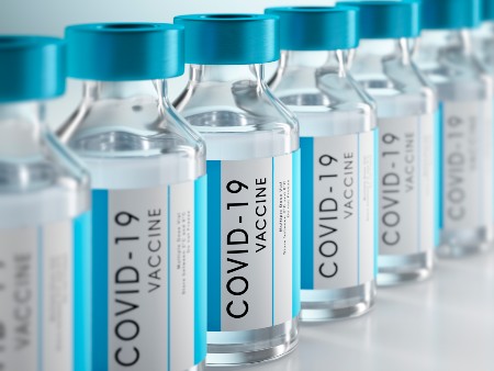 Vials of clear liquid marked with COVID-19 vaccine labels