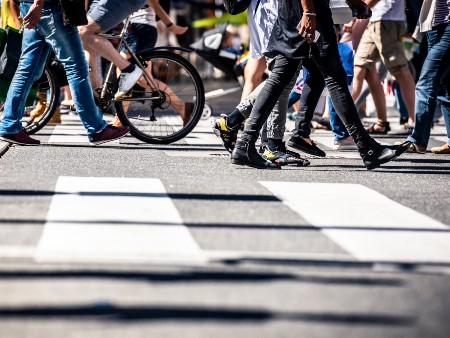 Busy street scene showing zebra crossings, pedestrians and bicycles