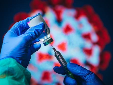 Medical practitioner prepares a COVID-19 vaccine.