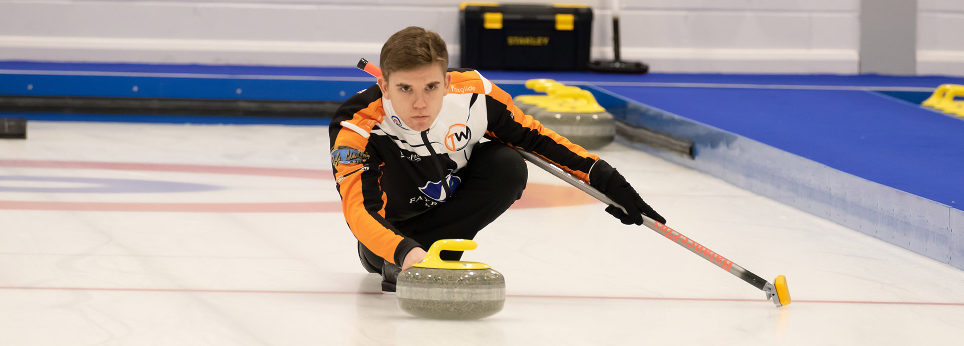 Ross Whyte pushing curling stone