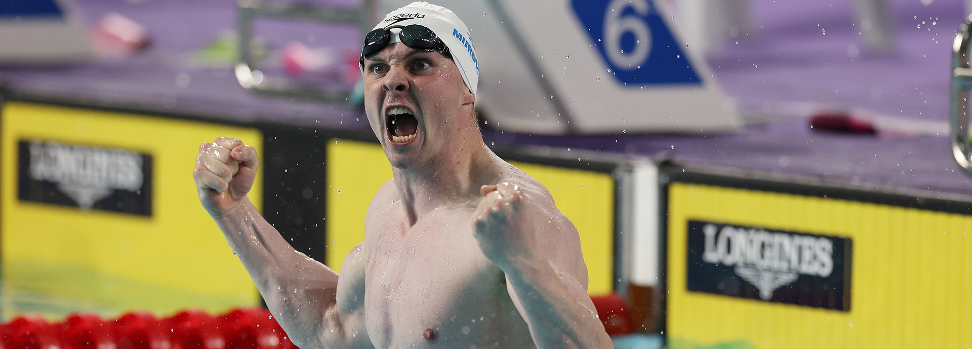 Ross Murdoch celebrating on swimming pool lane ropes