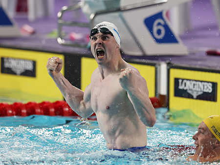 Ross Murdoch celebrating on swimming pool lane ropes