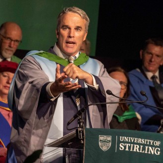 Lewis Pugh on stage giving his speech after receiving his honorary degree