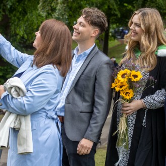 Family take a selfie at graduation