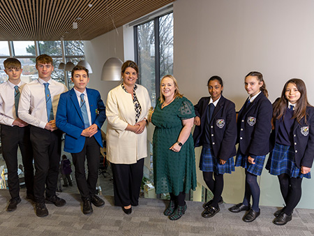 Students and staff standing next to each other