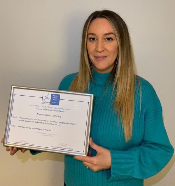 Anne Cumming photographed with her award certificate.