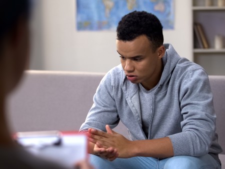 Young man speaking to counsellor.