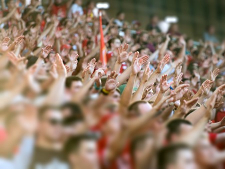 Crowd clapping on the podium of the stadium