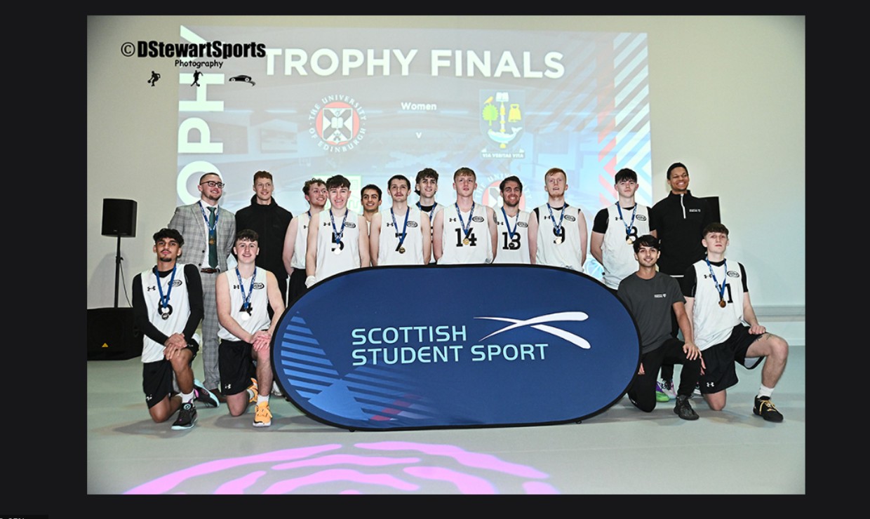 The 14-man University basketball team pose with their medals