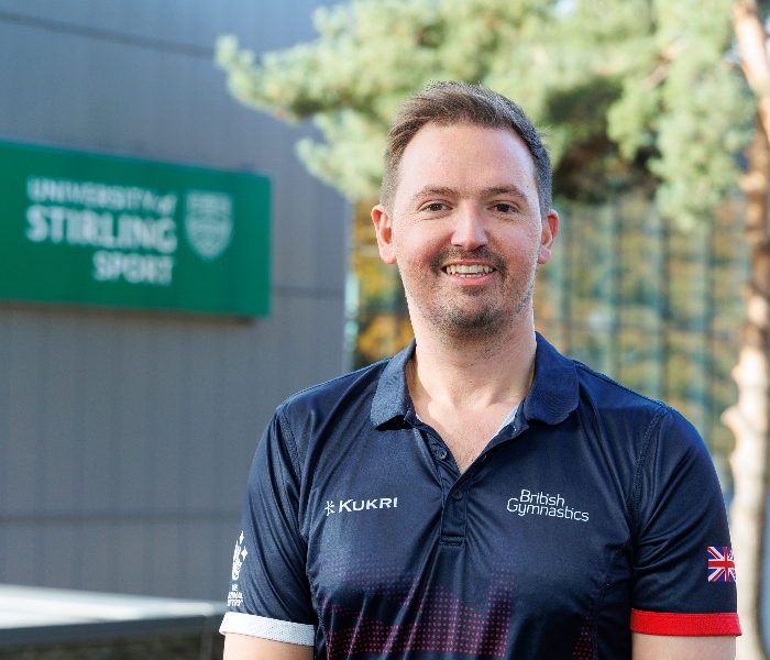 Paul Greaves stands outside in front of the University's Sports Centre