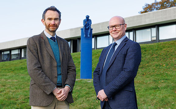 Two men pose with Blue Boy statue