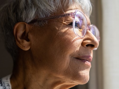 Older person looks out of window