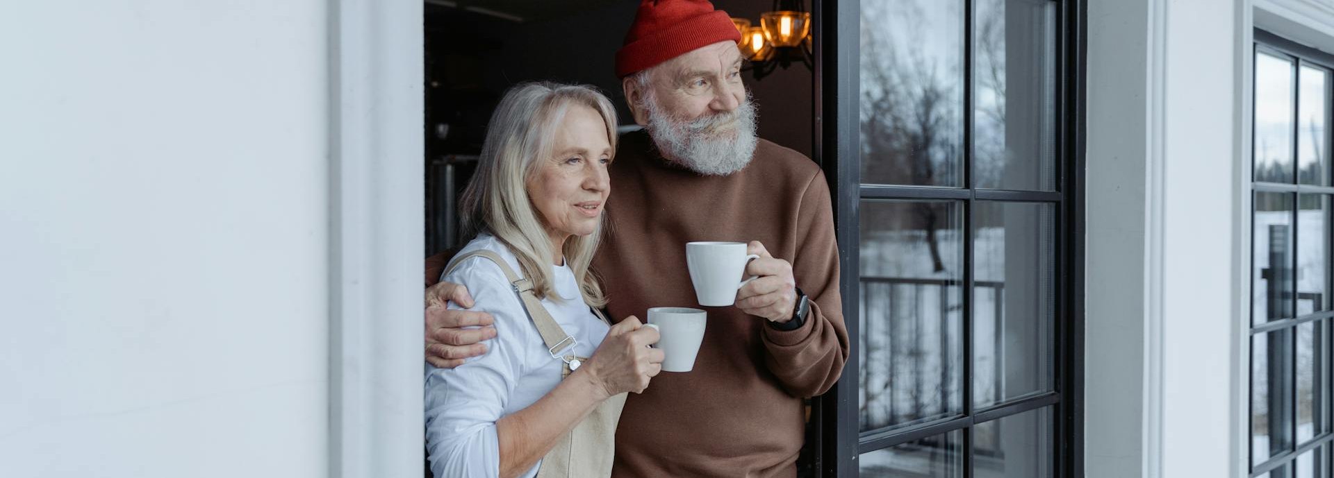 older man and woman outside house