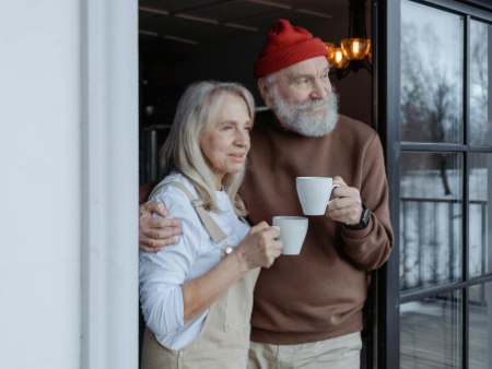 older man and woman outside home