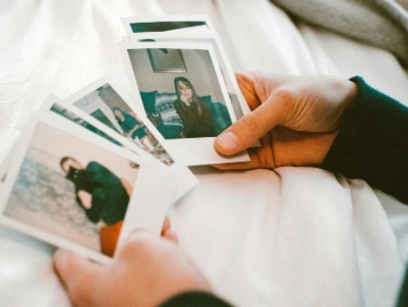 person's hands looking at photos